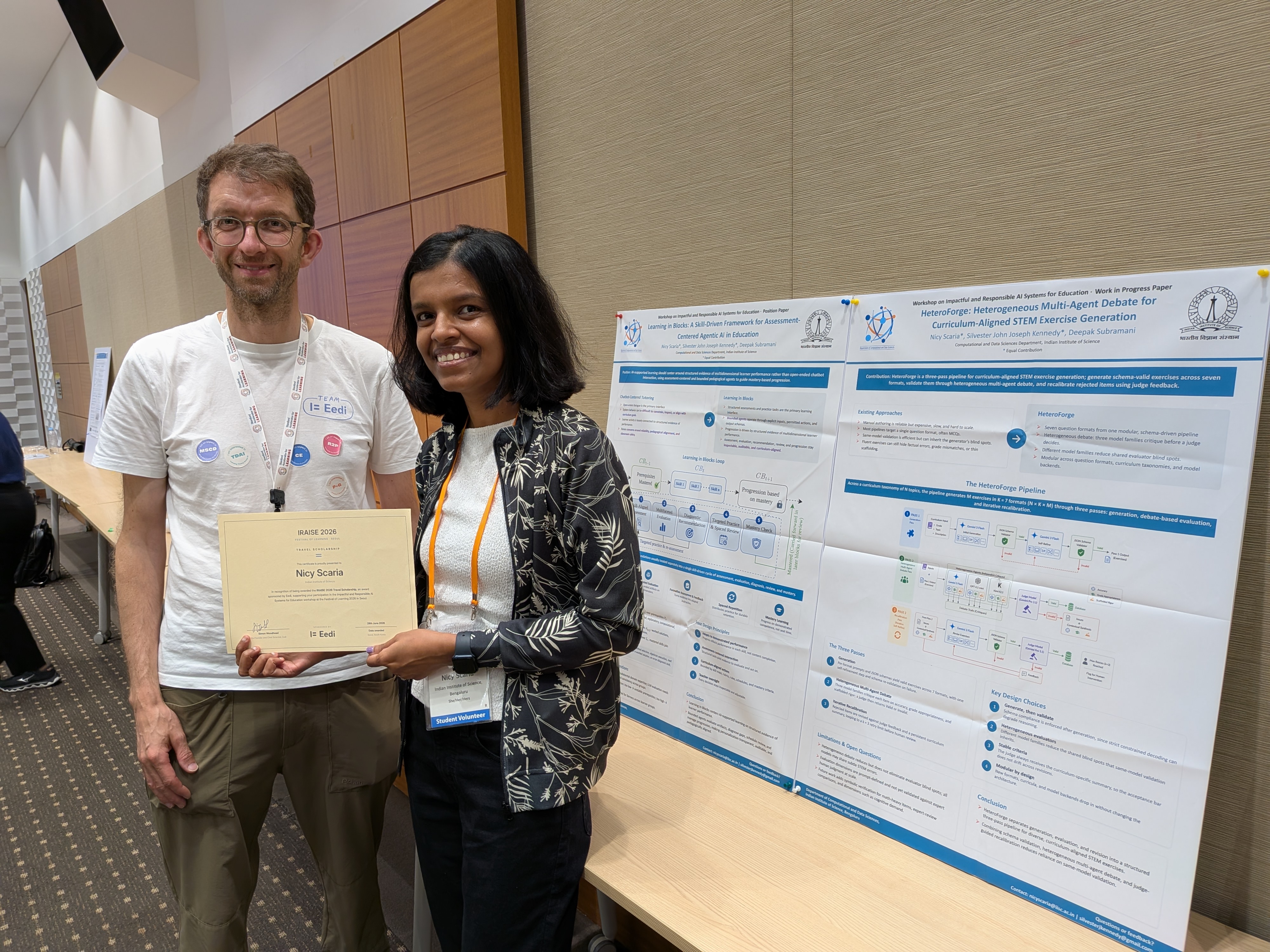 Simon Woodhead presenting the IRAISE 2026 travel scholarship certificate to Nicy Scaria